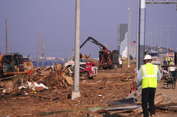 Construction teams clean up destruction after a hurricane